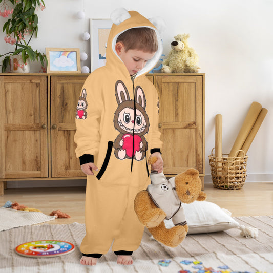 Child wearing a yellow onesie with bunny design in a room with wooden furniture and toys.