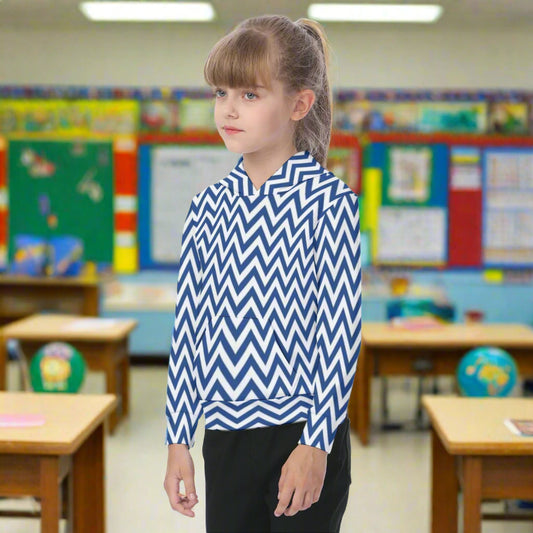 Child wearing a blue and white zigzag patterned shirt on a white background