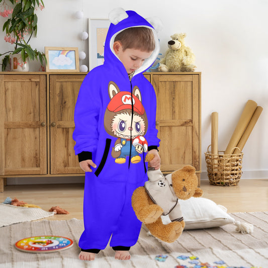 Child wearing a blue cartoon-themed onesie in a room with wooden furniture and toys.