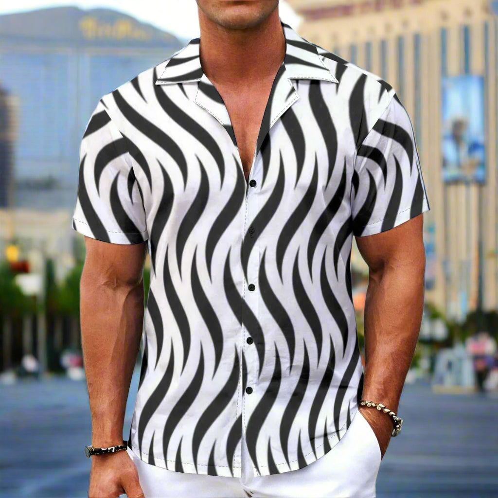 Man wearing a black and white zebra patterned shirt on a white background