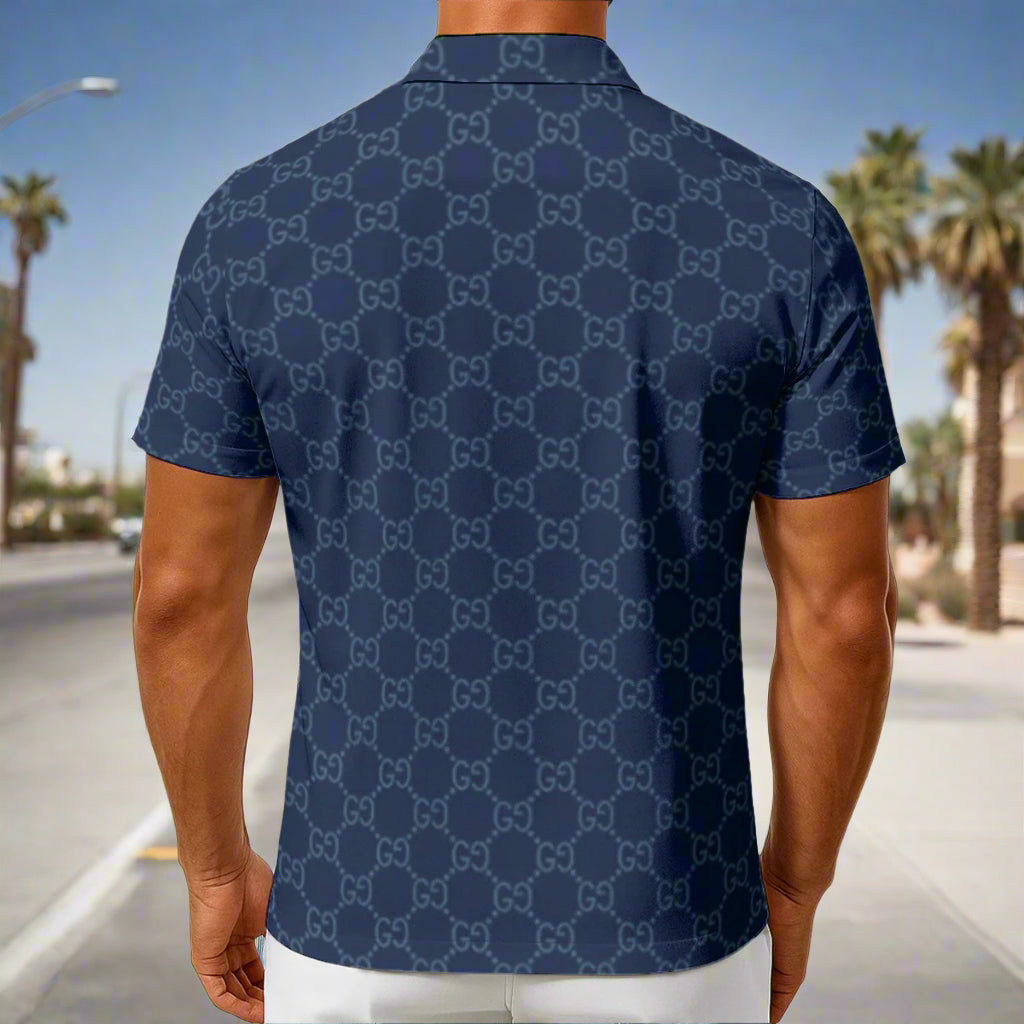 Man wearing a navy blue polo shirt with a geometric pattern on a white background