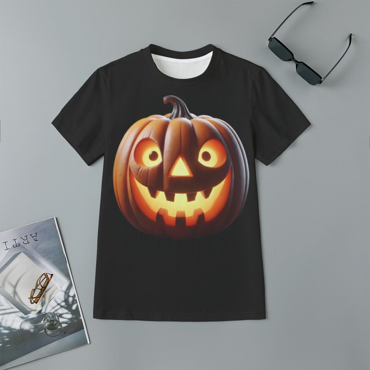 Black t-shirt with a pumpkin design on a gray surface