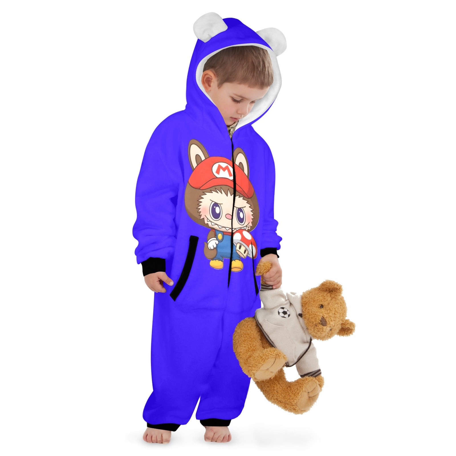Child wearing a blue onesie with cartoon character design, holding a teddy bear.