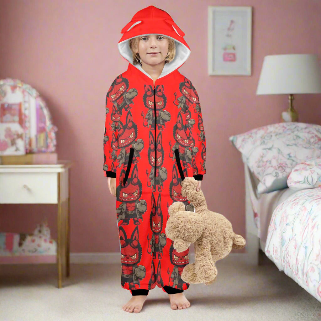 Child wearing a red onesie with black patterns, holding a teddy bear on a white background