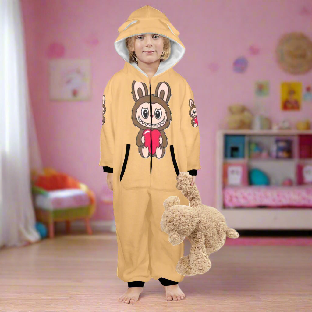 Child wearing a yellow onesie with a cartoon design, standing next to a small dog on a white background.
