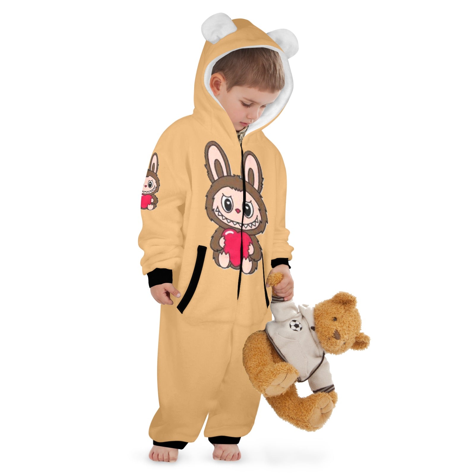 Child wearing a yellow onesie with cartoon character design, holding a teddy bear.